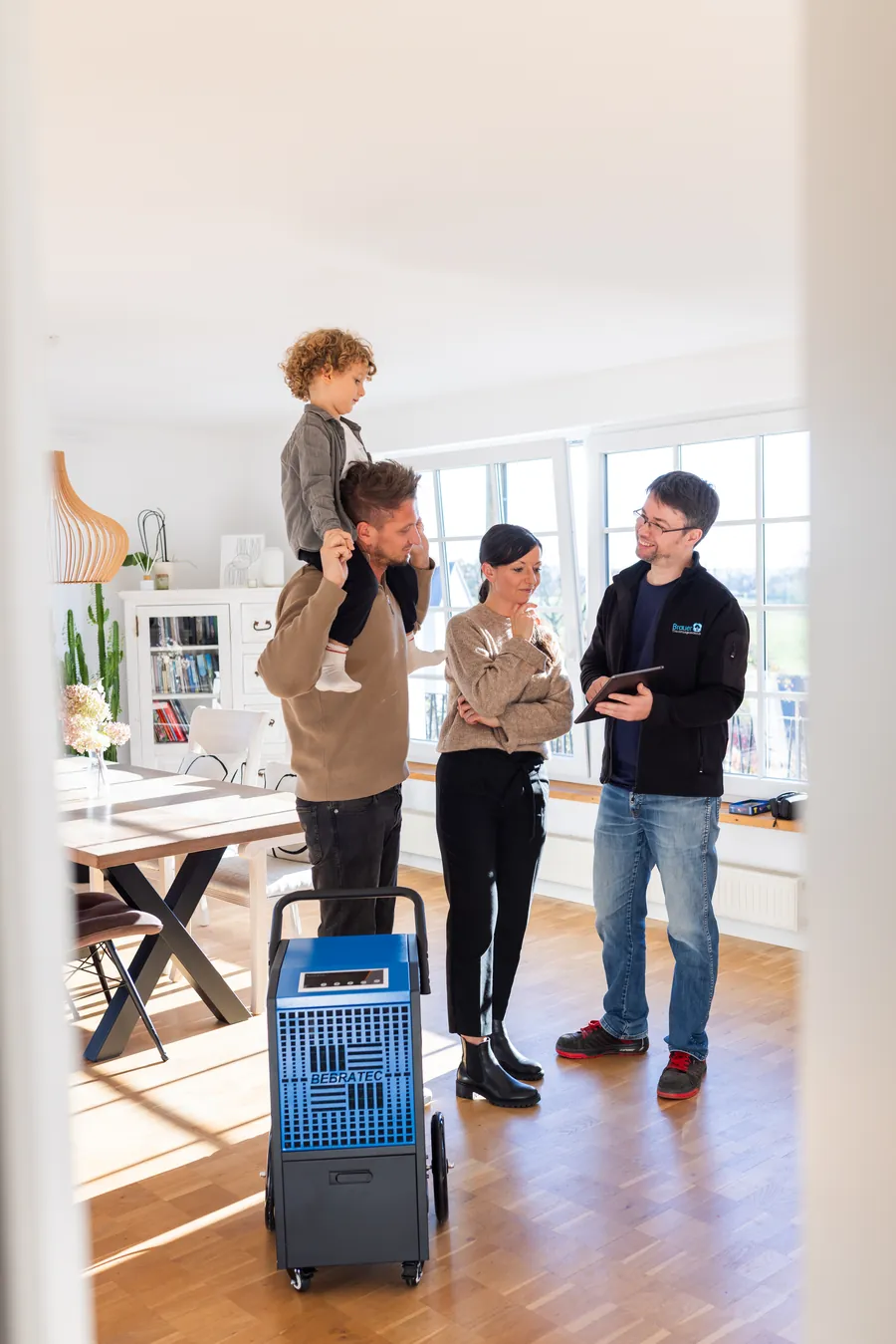 Familie mit Technikerin und Trocknungsgerät